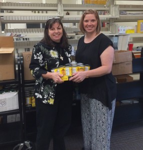 Staff holding canned food