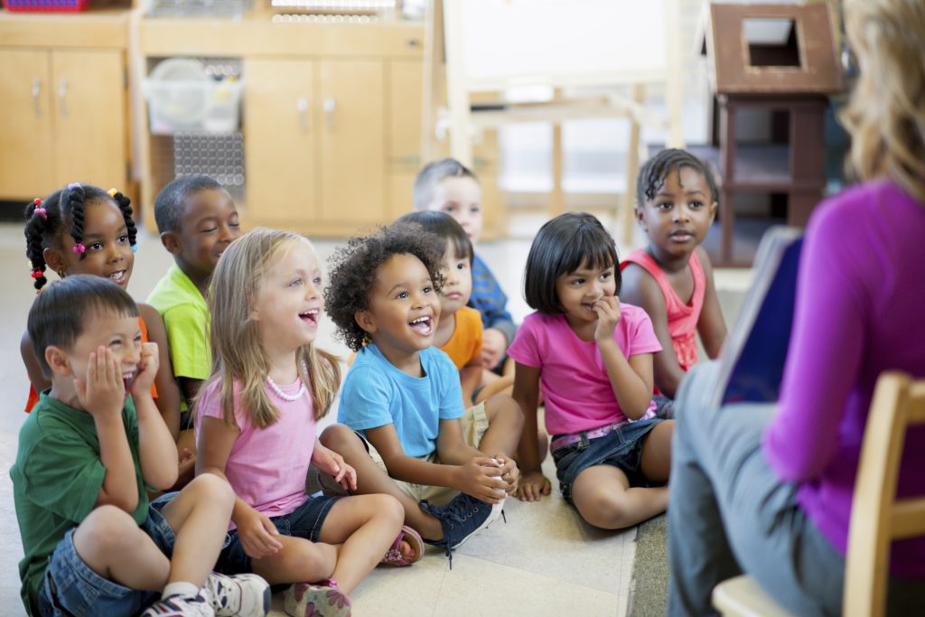 Preschool children in a classroom for story time.